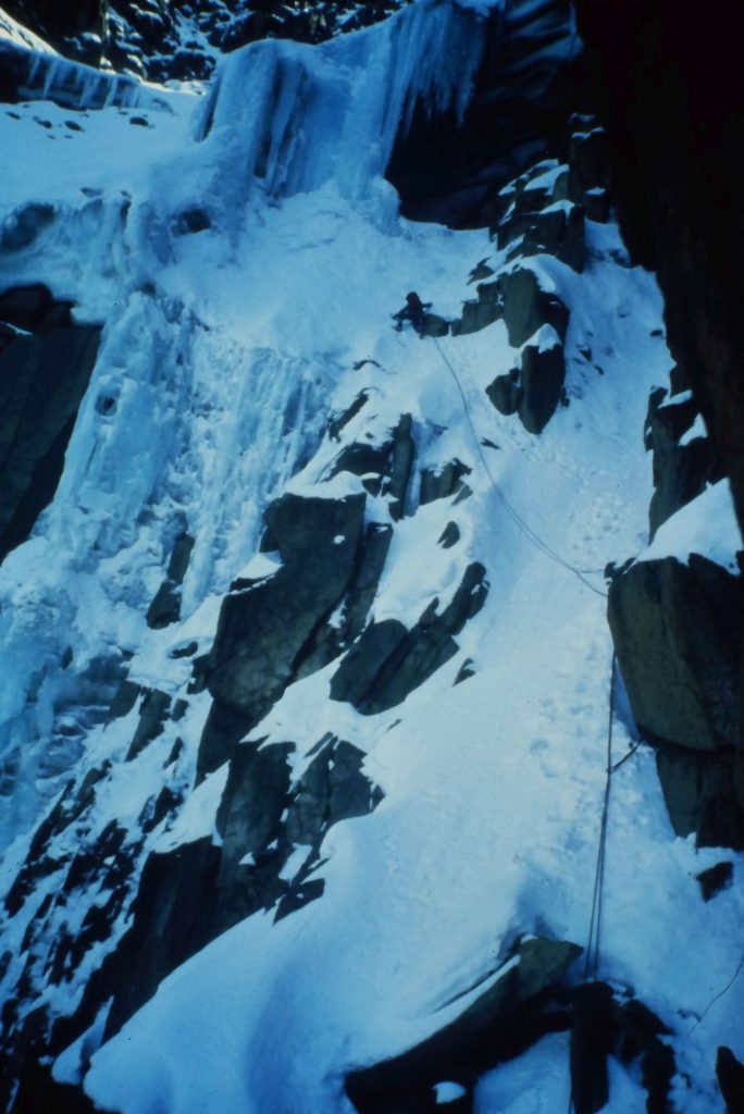 Traversing out of the gully towards the Ice Window behind the huge icicle screen